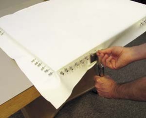 7. Continue stretching from corners inward, pulling with pliers and setting with pins. Centers remain unrestricted until the end.